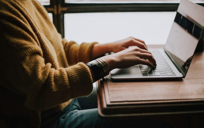 person sitting front of laptop